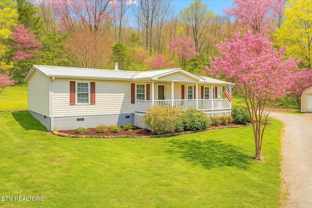 ranch-style house featuring a front yard, metal roof, crawl space, and covered porch