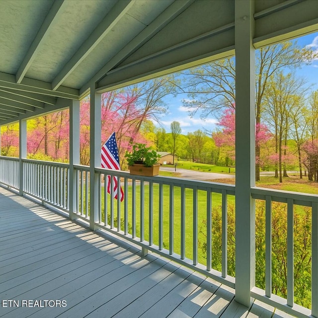 wooden deck with a lawn