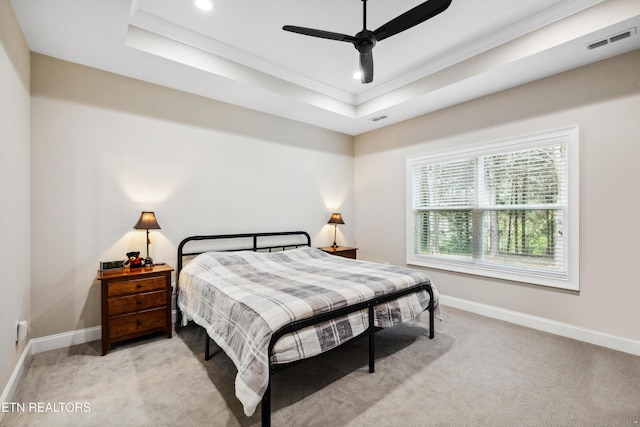 bedroom featuring a raised ceiling, light carpet, ornamental molding, recessed lighting, and baseboards