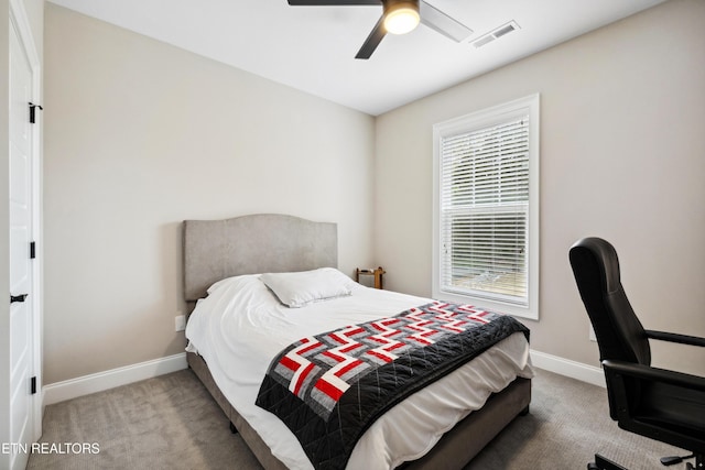 bedroom with baseboards, carpet floors, a ceiling fan, and a desk