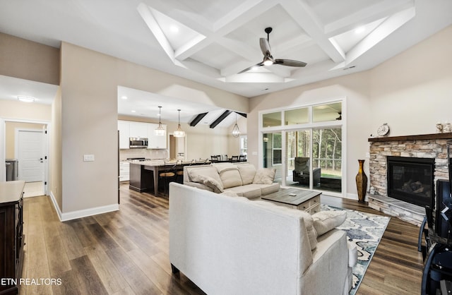 living room with a ceiling fan, recessed lighting, coffered ceiling, beam ceiling, and dark wood-style flooring