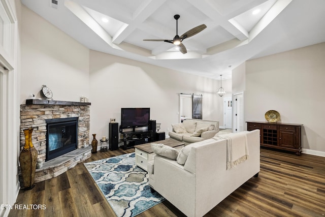 living room with ceiling fan, coffered ceiling, a stone fireplace, dark wood-style floors, and recessed lighting