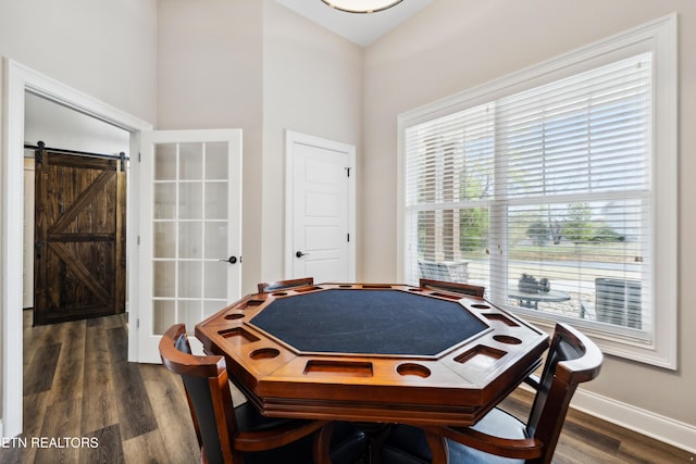 playroom featuring plenty of natural light, dark wood-style flooring, and baseboards