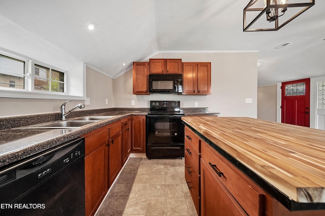 kitchen featuring wooden counters, brown cabinets, a sink, black appliances, and vaulted ceiling