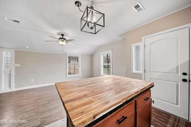 kitchen with visible vents, crown molding, wooden counters, ceiling fan, and dark wood-style floors