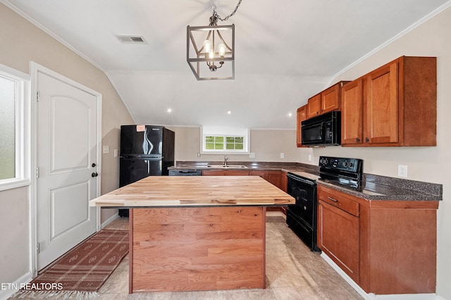 kitchen with crown molding, a center island, a sink, wood counters, and black appliances
