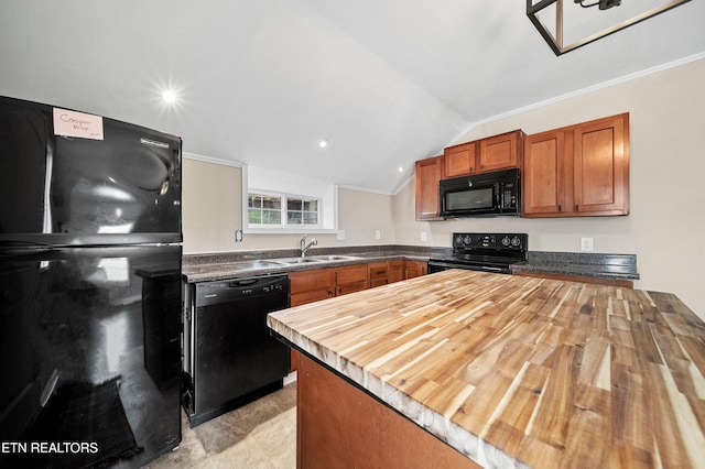 kitchen with a sink, black appliances, brown cabinets, lofted ceiling, and wood counters