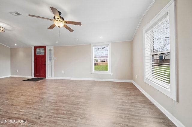 unfurnished living room featuring ornamental molding, baseboards, ceiling fan, and wood finished floors