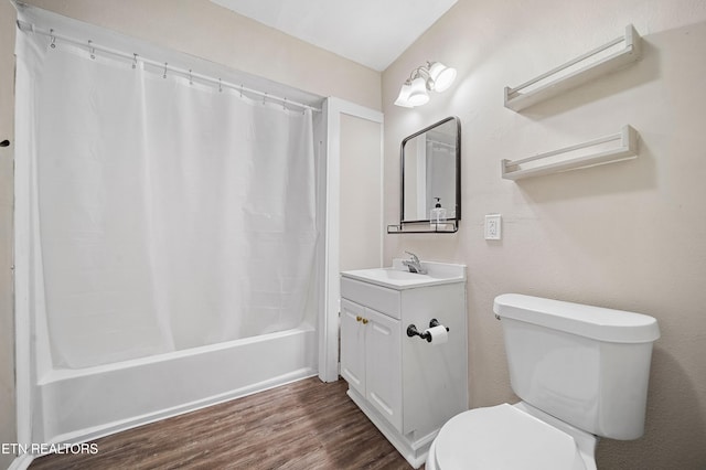 bathroom featuring toilet, vanity, shower / bathtub combination with curtain, and wood finished floors