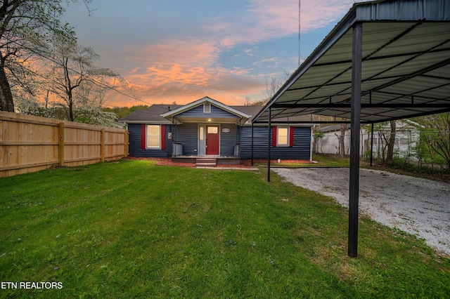 view of front facade featuring a lawn and fence
