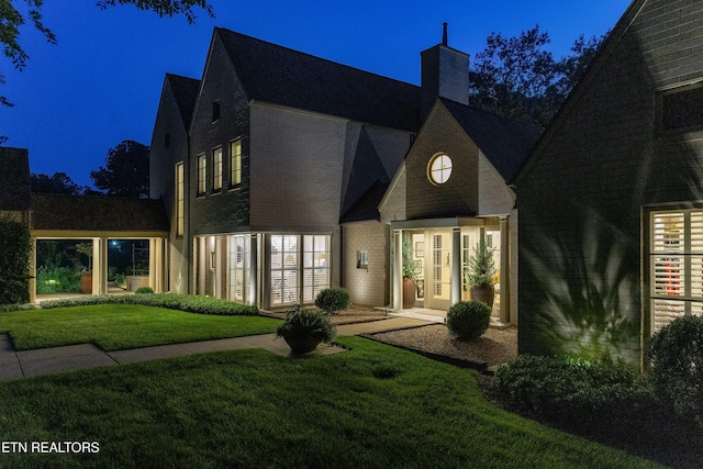 11901 S Fox Den Dr, Knoxville, TN 37934 - view of front of property featuring a chimney, a lawn, brick siding, and french doors