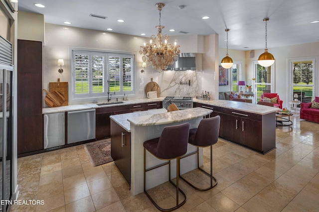 11901 S Fox Den Dr, Knoxville, TN 37934 - kitchen featuring stainless steel appliances, a peninsula, a kitchen island, backsplash, and a sink