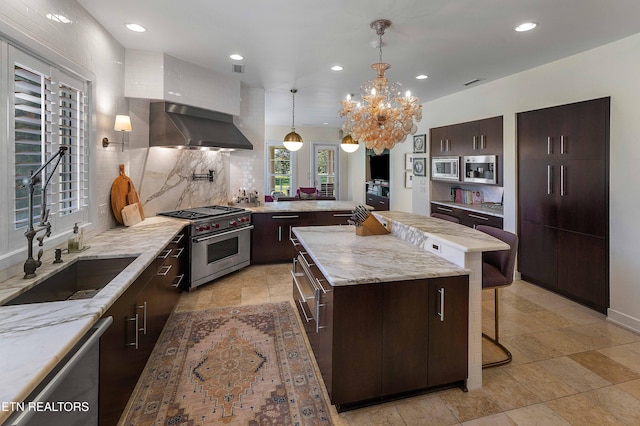 11901 S Fox Den Dr, Knoxville, TN 37934 - kitchen featuring wall chimney range hood, stainless steel appliances, a breakfast bar, recessed lighting, and backsplash
