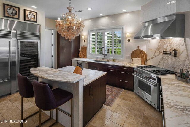 11901 S Fox Den Dr, Knoxville, TN 37934 - kitchen featuring appliances with stainless steel finishes, wall chimney range hood, beverage cooler, backsplash, and recessed lighting