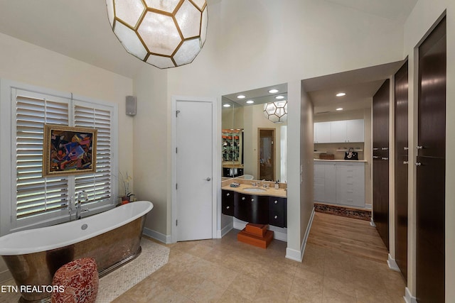 11901 S Fox Den Dr, Knoxville, TN 37934 - full bathroom featuring a freestanding bath, vanity, baseboards, a high ceiling, and recessed lighting