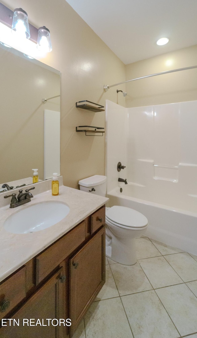 bathroom with toilet, vanity, shower / bath combination, and tile patterned flooring