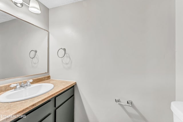 bathroom with toilet and vanity