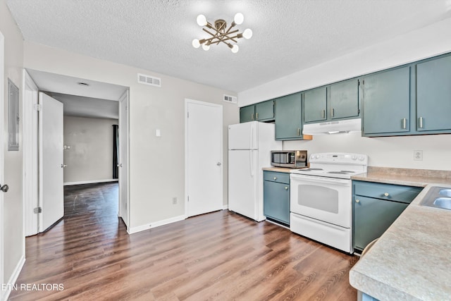 kitchen with a notable chandelier, white appliances, visible vents, and light countertops