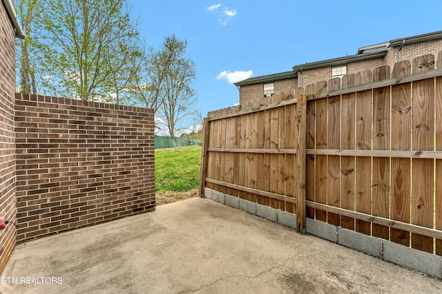 view of patio featuring fence