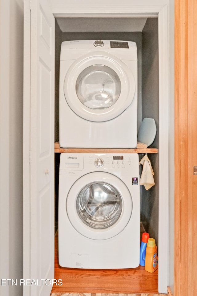 clothes washing area featuring laundry area and stacked washer / drying machine