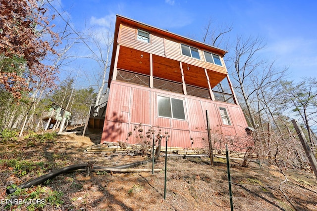 rear view of property with a balcony