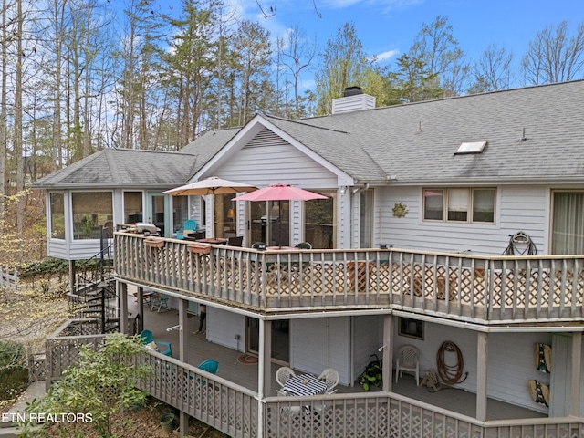 12 Wessex Ct, Crossville, TN 38558 - rear view of property with a sunroom, a deck, roof with shingles, and a chimney