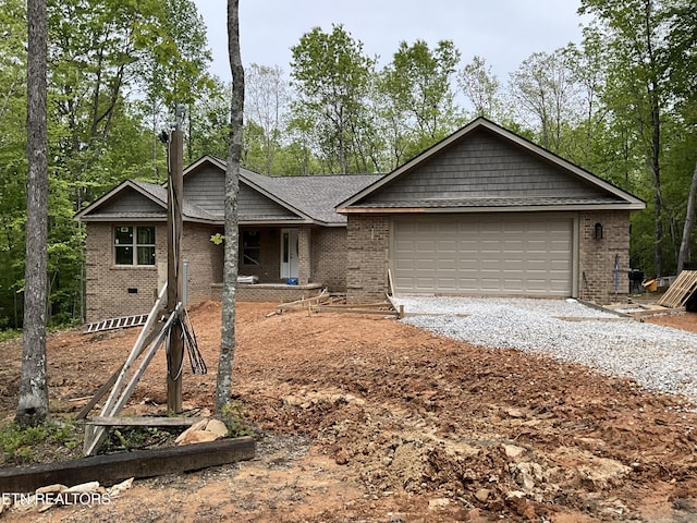 10 T Pl, Monterey, TN 38574 - ranch-style home featuring brick siding, gravel driveway, an attached garage, and view of scattered trees