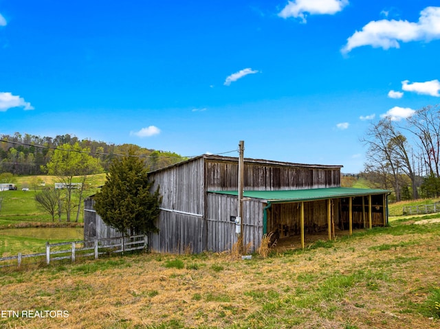 view of pole building with fence