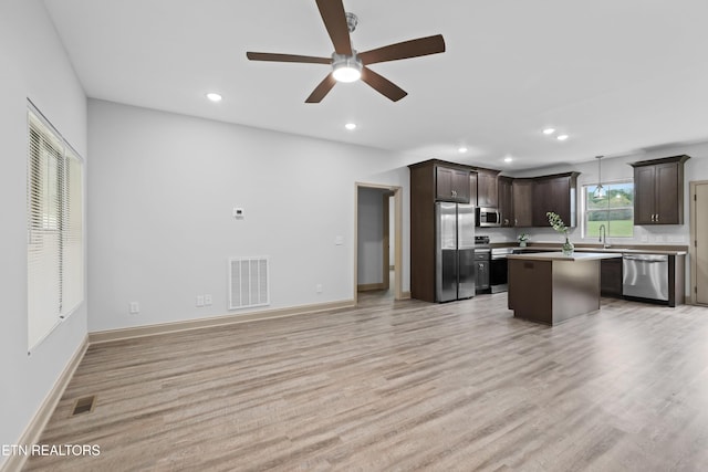 kitchen featuring ceiling fan, stainless steel appliances, dark brown cabinetry, and visible vents