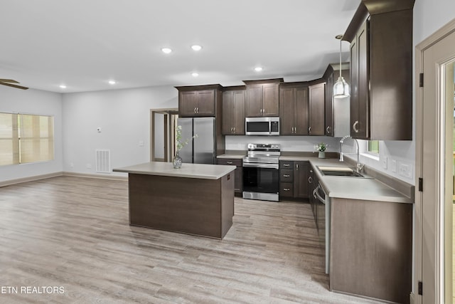 kitchen featuring recessed lighting, a sink, dark brown cabinets, and appliances with stainless steel finishes