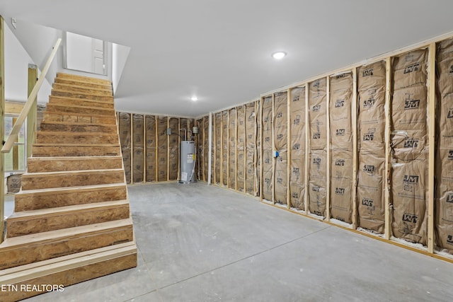 below grade area featuring water heater and stairway