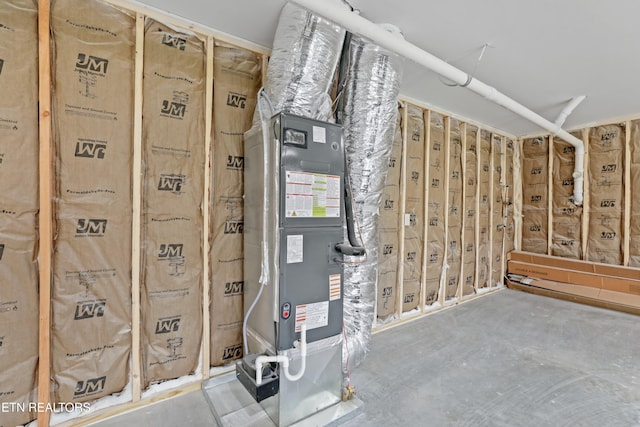 utility room featuring heating unit