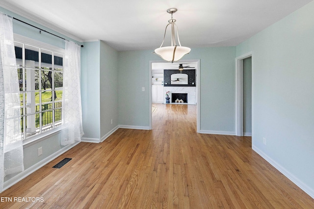 201 Farlow Dr, Knoxville, TN 37934 - unfurnished dining area with a large fireplace, visible vents, baseboards, and wood finished floors