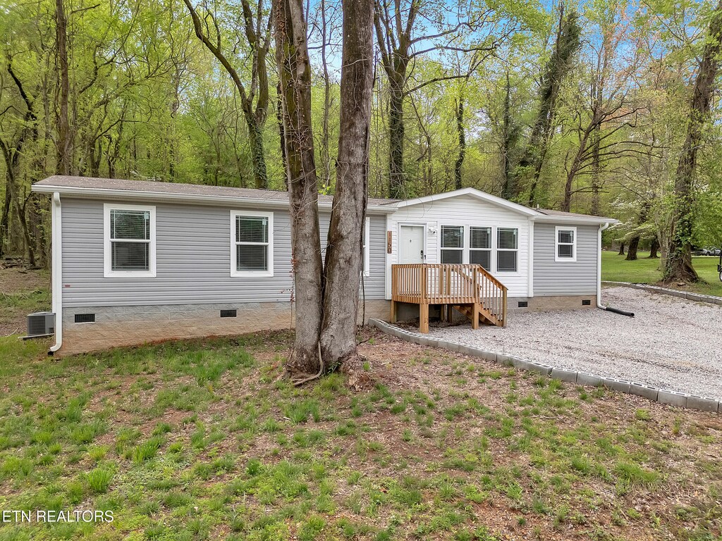 view of front of property featuring crawl space and central air condition unit