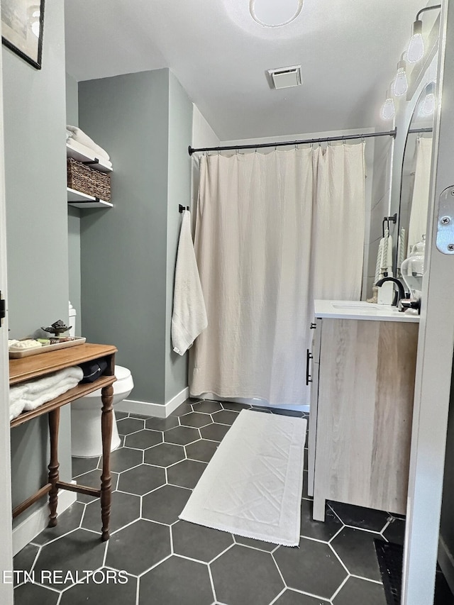bathroom with visible vents, toilet, tile patterned floors, curtained shower, and vanity