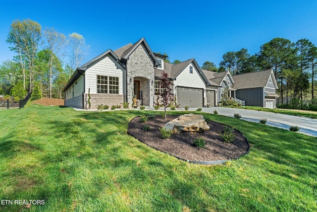 204 Atoka Pl, Loudon, TN 37774 - view of front facade with a front yard, an attached garage, stone siding, and concrete driveway