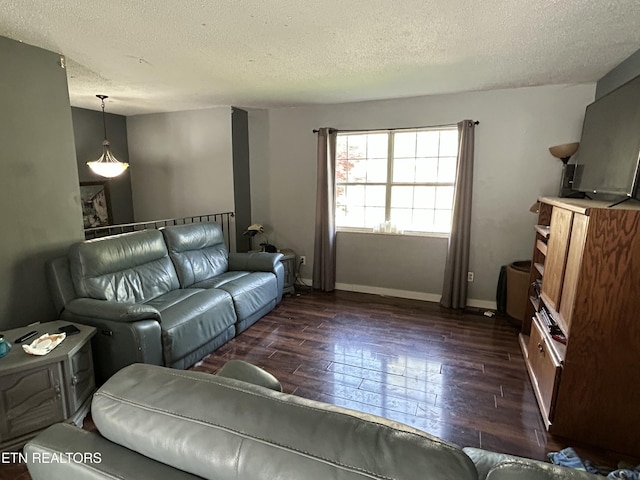 living area with dark wood-style floors, baseboards, and a textured ceiling