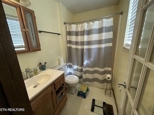 bathroom featuring toilet, curtained shower, vanity, tile patterned flooring, and visible vents