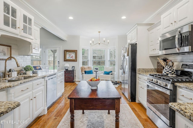 1798 Pearl Ave, Cookeville, TN 38506 - kitchen with crown molding, white cabinets, a sink, and stainless steel appliances