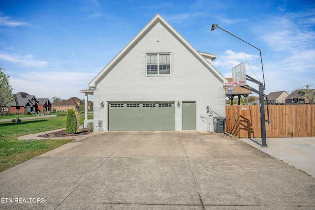 1798 Pearl Ave, Cookeville, TN 38506 - view of side of property with fence, a garage, concrete driveway, brick siding, and a yard