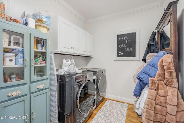 1798 Pearl Ave, Cookeville, TN 38506 - washroom featuring crown molding, baseboards, washing machine and clothes dryer, light wood-style flooring, and cabinet space