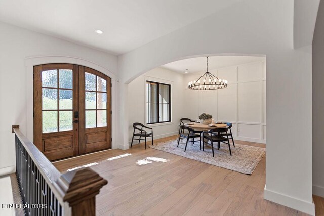 788 Blackberry Ridge Rd, Lenoir City, TN 37772 - foyer entrance with light wood-style flooring, arched walkways, french doors, a notable chandelier, and baseboards