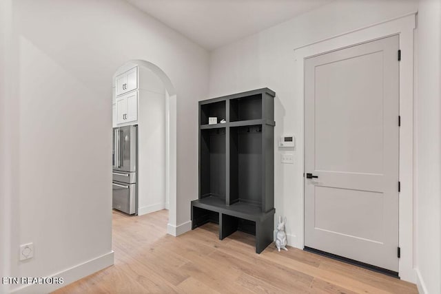 788 Blackberry Ridge Rd, Lenoir City, TN 37772 - mudroom featuring light wood-style flooring, arched walkways, and baseboards