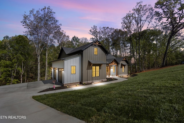 788 Blackberry Ridge Rd, Lenoir City, TN 37772 - view of front of home featuring board and batten siding, a yard, a garage, and concrete driveway