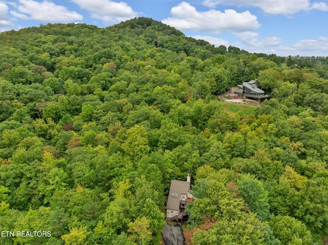 drone / aerial view featuring a forest view