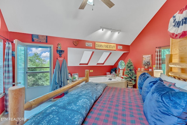 bedroom featuring rail lighting, ceiling fan, multiple windows, and lofted ceiling