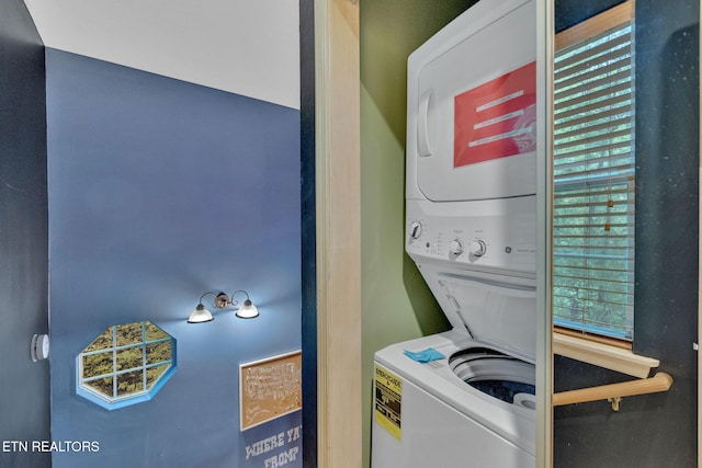 laundry area featuring stacked washer / dryer, laundry area, and plenty of natural light