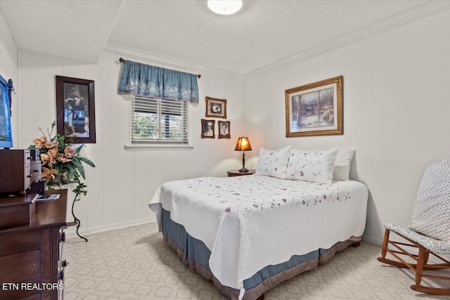 carpeted bedroom featuring crown molding, baseboards, and a textured ceiling