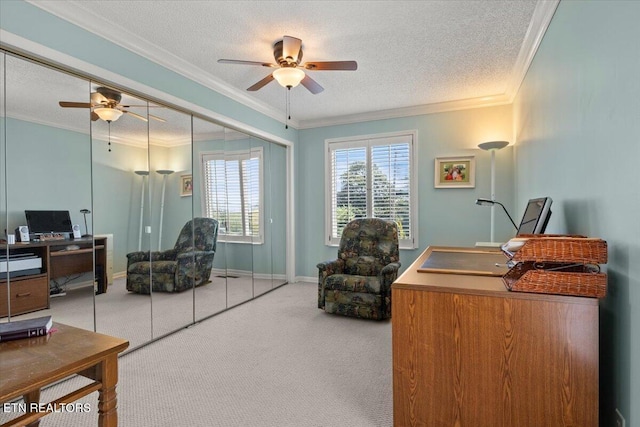 carpeted office with baseboards, a textured ceiling, crown molding, and ceiling fan