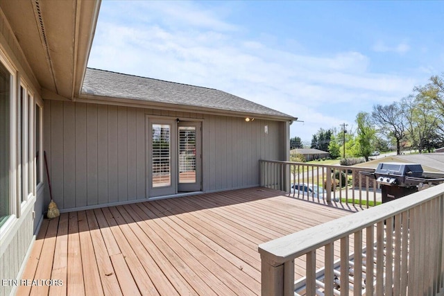 wooden terrace with a grill